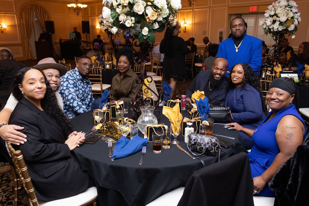 Guests gathered around a decorated birthday table