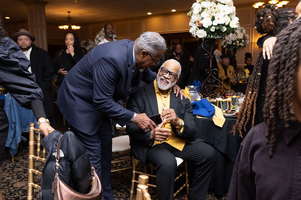 Pastor Motley sharing a candid smile with a guest at his birthday celebration