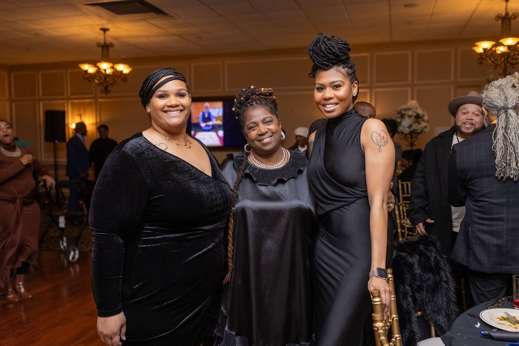Three guests smiling at the birthday celebration