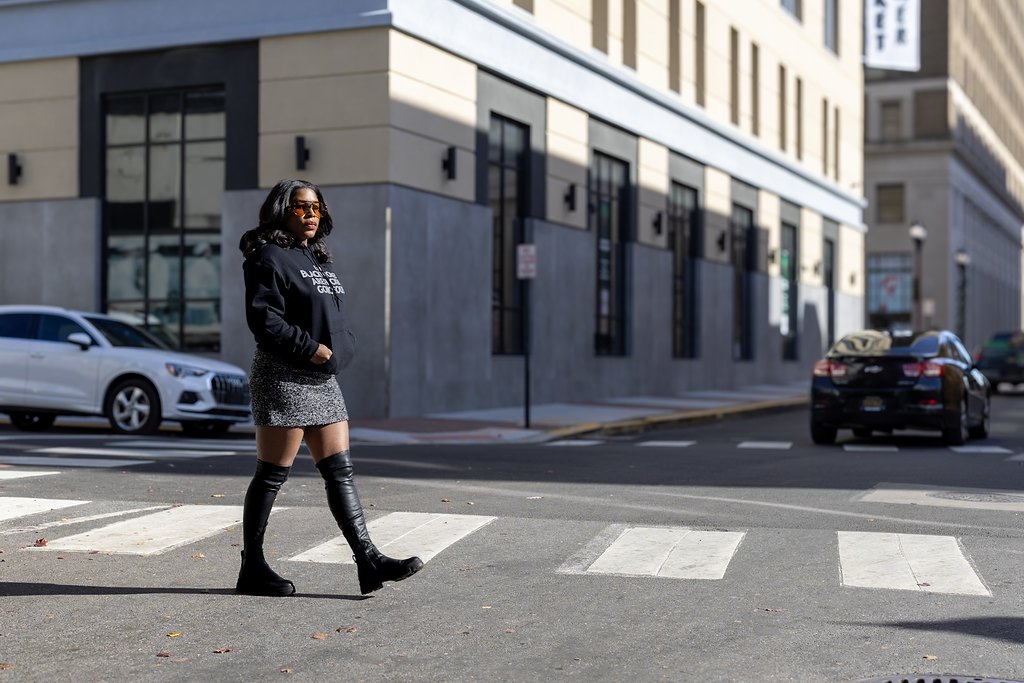Tia crossing a city street during her brand session